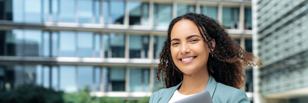 Woman Standing Outside in Front of an Office Building