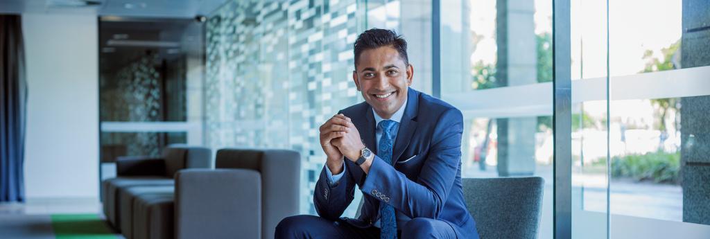 Businessman Sitting in Office Lobby