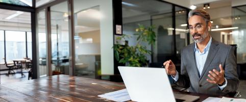Man working in office with airpods | CNA Insurance